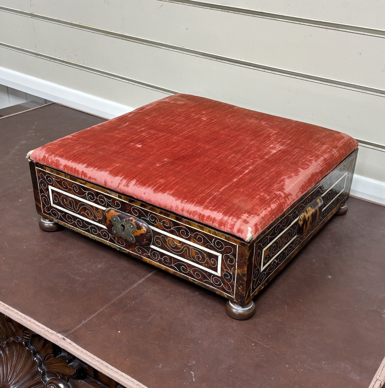 An 18th / early 19th century Portuguese tortoiseshell box with bone inlay and silk velvet lining with matching padded top, on bun feet, width 39cm, depth 38cm, height 16cm